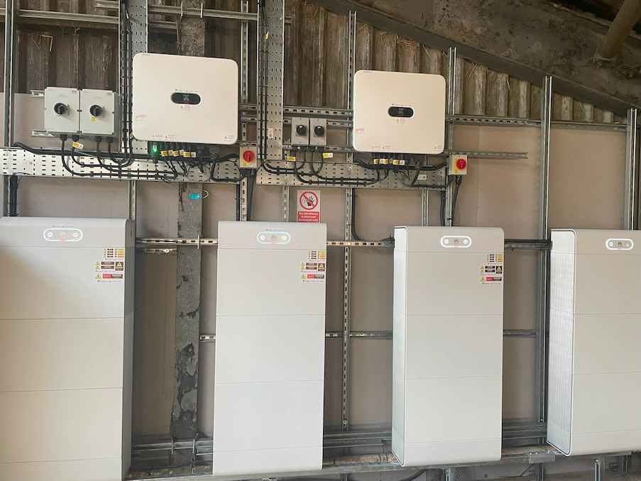 Solar inverters and battery storage units installed in a farm building